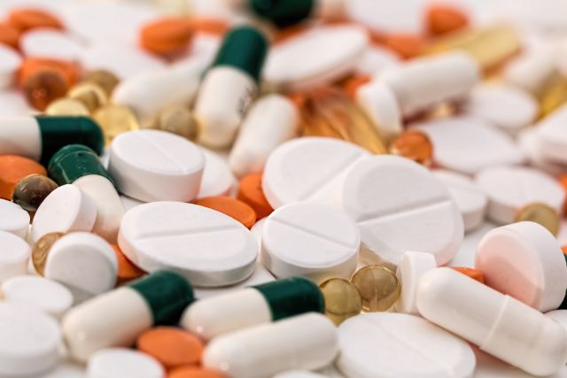 Canva - Bunch of White Oval Medication Tablets and White Medication Capsules